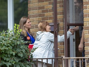 Lindsay Mathyssen, the NDP candidate in the riding of London Fanshawe, and her mother Irene Mathyssen who has held London Fanshawe seat for the last 13 years, meet Kevin Mulcair while campaigning door-to-door  in London. Derek Ruttan/The London Free Press/Postmedia Network