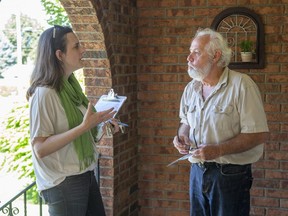 Green Party candidate Carol Dyck speaks with voter James Daley in the riding of London North Centre in London.  (Derek Ruttan/The London Free Press)