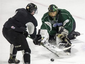 Jordan Kooy pokes away rebound before Gerard Keane can pounce on it during London Knight practice at Budweiser Gardens in London on Wednesday. (Derek Ruttan/The London Free Press)