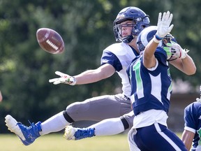 Cole Moore makes a valiant attempt but can't quite make the one-handed catch while covered by Cole Manier  in London, Ont. on Thursday September 26, 2019. Moore's Parkside Stampeders fell to Manier's home team Laurier Rams, 29-22. Derek Ruttan/The London Free Press/Postmedia Network