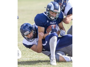 Parkside's Paul Moore tackles Laurier's Sebastian DeLeon Kantule in TVRA action in London on Thursday. (Derek Ruttan, The London Free Press)