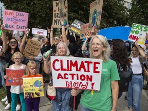 Brandishing a sign demanding action on climate change, Green Party candidate Mary Ann Hodge joins a throng of climate-change protesters in downtown London on Friday in one of a series of Fridays For Future events held across the world, inspired by youth activist Greta Thunberg who began the movement last year. Large crowds gathered near city hall and in Victoria Park for Friday's demonstration. Hodge, one of the event organizers, is making her third run for the Green Party in federal politics and her first in London West in the Oct. 21 election. (DEREK RUTTAN, The London Free Press)