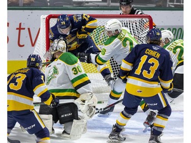 Josh Nelson checks Erie Otter Connor Lockhart into the net behind London Knights goalie Brett Brochu during the first period of their OHL game at Budweiser Gardens in London, Ont. on Friday Sept. 27, 2019. Derek Ruttan/The London Free Press
