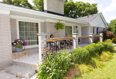 LOOKING GOOD IN THE HOOD

Londoners Janet and Dave Hassall enjoy the expansive porch of their East Mile Road home in Oakridge. The addition was constructed by their son about five years ago. (MIKE HENSEN, The London Free Press)