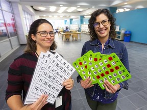 Lily Keightley the London Public Library's outreach librarian and Michelle Dellamora of Age Friendly London show off bingo cards made larger and easier for older adults. The cards are among many resources and tools on loan from the library to help seniors stay active.  (Mike Hensen/The London Free Press)