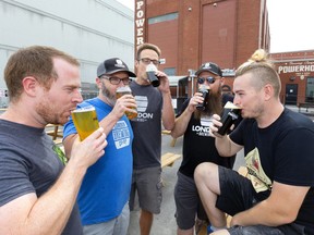 Sampling of the wares is a time honoured beer makers custom as Gavin Anderson of Anderson Ales, Tim Stewart, Aaron Lawrence and Chris Dawdy of London Brewing Co-op and Chris Patterson of Powerhouse Brewing Company toast Powerhouse’s new patio on their property located on the east end of the old Kellogg factory. (Mike Hensen, The London Free Press)