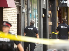 A man with what police are calling a "sharp-edged weapon" was arrested on King Street just east of Richmond Street in downtown London on Tuesday September 3, 2019.  Two gunshots were fired during the morning conflict, police say, though it's unclear by whom. Mike Hensen/The London Free Press/Postmedia Network