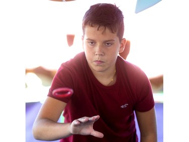 Camden Carmichael tosses a ring to no effect as he didn't win a prize at the age-old ring toss at the Western Fair's opening day on Friday. (Mike Hensen/The London Free Press)