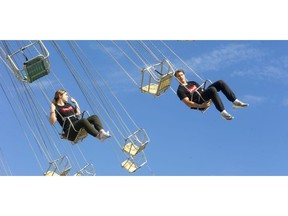 Kayla Sutherland and Trenton Camick, both of Clarke Road secondary school, were among the first to get on the rides at the Western Fair's opening day on Friday. (Mike Hensen/The London Free Press)