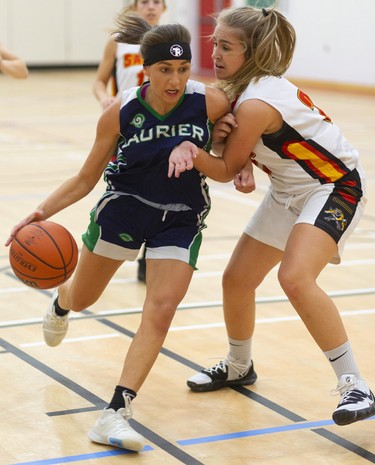 Keren Hasebenebi of the Laurier Rams drives past Julianna Rizzo of the Saunders Sabres during their TVRA Central senior girls basketball game at Saunders on Monday September 30, 2019. 
Laurier dominated throughout with a good press and defence that forced the Sabres to cough up a lot of turnovers.
Mike Hensen/The London Free Press/Postmedia Network