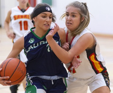 Keren Hasebenebi of the Laurier Rams drives past Julianna Rizzo of the Saunders Sabres during their TVRA Central senior girls basketball game at Saunders on Monday September 30, 2019. 
Laurier dominated throughout with a good press and defence that forced the Sabres to cough up a lot of turnovers.
Mike Hensen/The London Free Press/Postmedia Network