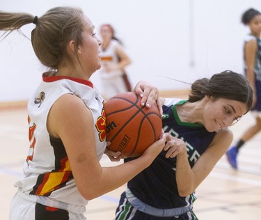 Julianna Rizzo of the Saunders Sabres wrests a defensive rebound away from Anna Roboulias of the Laurier Rams  during their TVRA Central senior girls basketball game at Saunders on Monday September 30, 2019. 
Laurier dominated throughout with a good press and defence that forced the Sabres to cough up a lot of turnovers.
Mike Hensen/The London Free Press/Postmedia Network