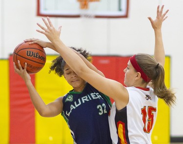 Olivia Hatchett of the Laurier Rams protects the ball as she goes in on Naomi Tufts of the Saunders Sabres during their TVRA Central senior girls basketball game at Saunders on Monday September 30, 2019. 
Laurier dominated throughout with a good press and defence that forced the Sabres to cough up a lot of turnovers.
Mike Hensen/The London Free Press/Postmedia Network