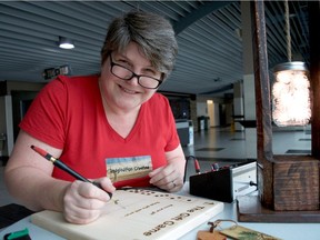 Pyrographer Renee Sferrazza works on a piece inside Budweiser Gardens for the second annual artisans' and performers' showcase last November. The third edition is taking place Nov. 3, 2019. (CHRIS MONTANINI, Postmedia Network files)