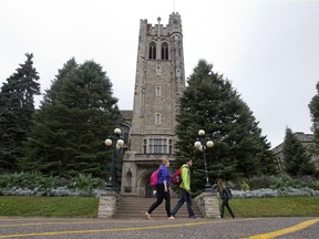 Students walk past the iconic University College tower on the Western University campus. (File photo)