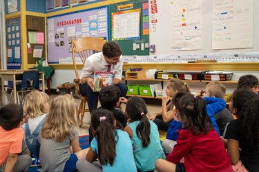 Prime Minister Justin Trudeau reads Why I Love Canada to a group of grade 1 and 2 pupils at Blessed Sacrament Catholic elementary school on Sept. 16 during a campaign stop in London. (MAX MARTIN, The London Free Press)