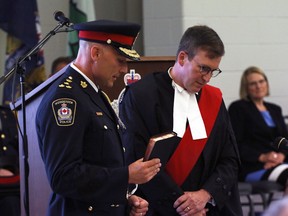 Daryl Longworth is sworn in by Justice M.E. Graham as the 27th chief of the Woodstock Police Service on Wednesday in Goff Hall. Greg Colgan/Sentinel-Review