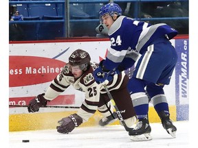Peter Stratis, right, of the Sudbury Wolves, knocks Ryan Merkley, of the Peterborough Petes, to the ice during OHL action at the Sudbury Community Arena in Sudbury, Ont. on Friday January 25, 2019.  Merkley is now a member of the London Knights. (John Lappa/Postmedia Network)