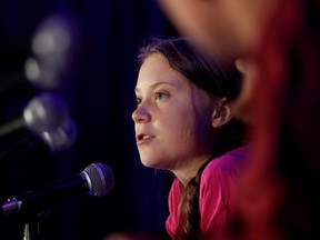 Swedish climate activist Greta Thunberg speaks with other child petitioners who presented a landmark complaint to the United Nations Committee on the Rights of the Child about the lack of government action on the climate crisis in September. (Shannon Stapleton/Reuters)