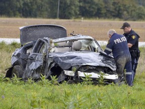Police investigate a rural crash of a single vehicle Oct. 4 in Lambton County south of Petrolia. Three people were pronounced dead and one other rushed to hospital. (Louis Pin/The Sarnia Observer)