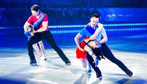 Patrick Chan (Front) and Scott Moir (Back) dance with Tessa Virtue and Carolina Kostner (Respectively) during the Rock the Rink performance. (File photo)