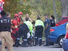 Paramedics treat a man after he was pulled from the Thames River Tuesday morning in northeast London. (JONATHAN JUHA, The London Free Press)