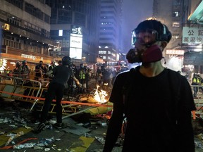 Protesters don gas masks to protect themselves from tear gas and fires in Hong Kong. (Alex Stirling-Reed photo)