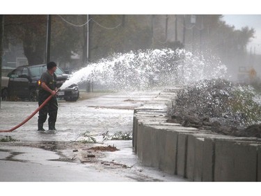 The familiar task of pumping out water from another storm on Erie Shore Drive near Erieau, Ont. took place again on Sunday after the area was slammed by power waves from gusts of wind forecasted by Environment Canada to reach up to 60 km/hr. (Ellwood Shreve/Postmedia Network)
