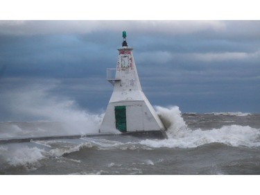 Powerful waves were crashing into the lighthouse at Erieau, Ontario on Sunday October 27, 2019 making it unsafe to be on the pier. (Ellwood Shreve/Postmedia Network)