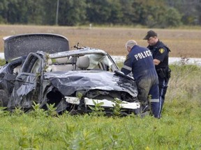 Police are shown in file photo investigating a single-vehicle crash site Oct. 4 on Oil Heritage Line near Oil Springs where three 19-year-old students from India were killed. A man charged following the crash was granted bail Thursday in Sarnia court.