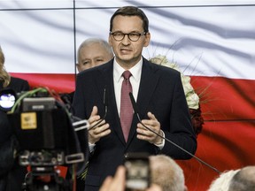 Poland's Prime Minister, Mateusz Morawiecki from the right-wing Law and Justice political party (PiS), speaks to supporters following the announcement of first results in Polish parliamentary elections on October 13, 2019 in Warsaw, Poland. PiS reached a result of 43 percent after the first projections.