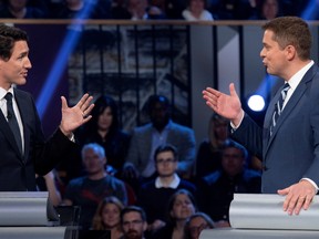 Conservative Leader Andrew Scheer and Liberal Leader Justin Trudeau gesture to each other during the federal leaders debate in Gatineau, Quebec on Oct. 7, 2019. (Reuters)