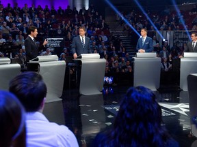 Bloc Quebecois leader Yves-Francois Blanchet, People's Party of Canada leader Maxime Bernier and Conservative leader Andrew Scheer listen to Liberal leader Justin Trudeau during the Federal leaders debate in Gatineau, Quebec, Canada October 7, 2019. Sean Kilpatrick/Pool via REUTERS