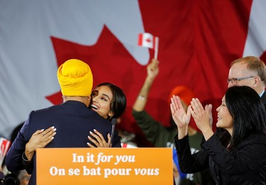 New Democratic Party leader Jagmeet Singh hugs wife Gurkiran Kaur Sidhu as NDP MPs Peter Julian and Jenny Kwan clap at an NDP election night party in Burnaby, British Columbia, Canada, October 21, 2019.  REUTERS/Lindsey Wasson ORG XMIT: GGG-BUR156