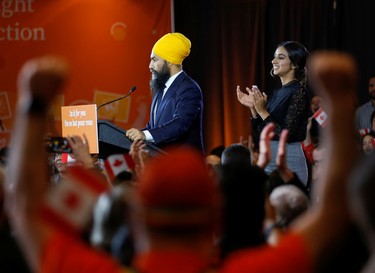 New Democratic Party leader Jagmeet Singh speaks to supporters after being re-elected in Burnaby South as wife Gurkiran Kaur Sidhu claps at an NDP election night party in Burnaby, British Columbia, Canada, October 21, 2019.  REUTERS/Lindsey Wasson ORG XMIT: GGG-BUR155