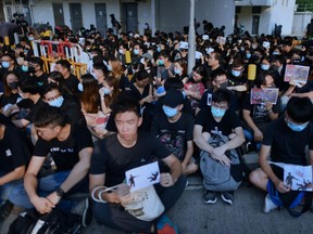 Students and protesters gather in support of form five student Tsang Chi-kin, 18, who was shot in the chest by police during violent pro-democracy protests that coincided with China's October 1 National Day, during a protest at a school in Hong Kong on October 2, 2019. - Hundreds of Hong Kongers staged a sit-in on October 2 outside the school of a protester who was shot by police as authorities said the wounded 18-year-old was now in a stable condition. (Photo by Mohd RASFAN / AFP) (Photo by MOHD RASFAN/AFP via Getty Images)