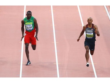 London's Damian Warner, right, finishes first among all decathletes in the 100-metre dash in a time of 10.35 seconds at the World Athletics Championships in Doha,  Qatar, on Tuesday. Running against him is Grenada's Lindon Victor.
