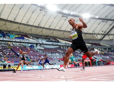 London's Damian Warner, right, finishes first among all decathletes in the 100-metre dash in a time of 10.35 seconds at the World Athletics Championships in Doha, Qatar, on Tuesday. Running second was Canada's Pierce Lepage, far left.