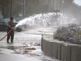 The familiar task of pumping out water from another storm on Erie Shore Drive near Erieau, Ont. took place again on Sunday after the area was slammed by power waves from gusts of wind forecasted by Environment Canada to reach up to 60 km/hr. (Ellwood Shreve/Postmedia Network)