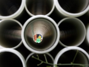 An employee of Tri-Con Excavation is seen through a stack of pipes on Horton St. in London, Ontario on Monday, June 11, 2012.  Installation of a new sanitary sewer system under Horton St. bewtween Wellington St and and Colborne St. will last cause lane reductions until the end of October. DEREK RUTTAN/ The London Free Press /QMI AGENCY