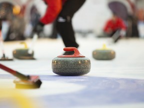 Sport of curling being played on a field