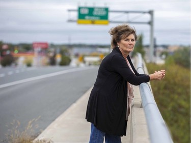 Anne English stands on the Wellington Road overpass that spans Highway 401 in London on Wednesday. Her sister Jackie English was 15 when she was last seen alive on the bridge 50 years ago. A memorial will be held Friday. (Derek Ruttan/The London Free Press)
