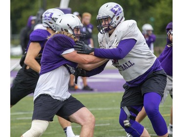 Defensive lineman Mark Shelley, left, confronts offensive lineman Phillip Grohovac during Western Mustangs football practice in London, Ont. on Thursday Oct. 3, 2019. Derek Ruttan/The London Free Press