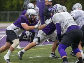 Defensive lineman Mark Shelley, left, confronts offensive lineman Phillip Grohovac during Western Mustangs football practice in London, Ont. on Thursday Oct. 3, 2019. (Derek Ruttan/The London Free Press)