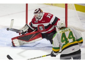 Ottawa 67's goalie Cedrick Andree makes a save in front of London Knight Jonathan Gruden during the first period of their OHL hockey game in London, Ont. on Friday October 4, 2019. (Derek Ruttan/The London Free Press)