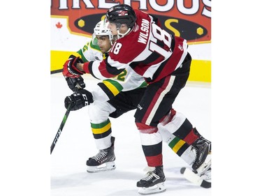 Ottawa 67 Hudson Wilson and London Knight Sahil Panwar stick together during the first period of their OHL hockey game in London on Friday. (Derek Ruttan/The London Free Press)