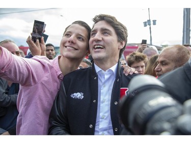 Liberal Party leader Justin Trudeau has a photo taken with a supporter during a campaign stop at the campaign office of  London-Fashawe candidate Mohamed Hammoud in London, Ont. on Monday October 14, 2019. .Derek Ruttan/The London Free Press/Postmedia Network