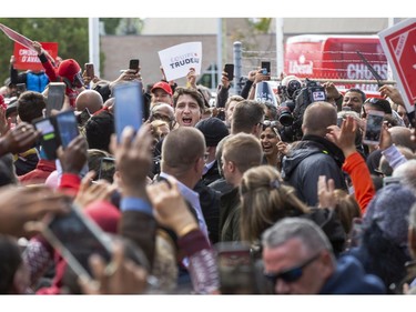 Liberal Party leader Justin Trudeau wades through a sea of supporters during a campaign stop at the campaign office of  London-Fashawe candidate Mohamed Hammoud in London, Ont. on Monday October 14, 2019. .Derek Ruttan/The London Free Press/Postmedia Network