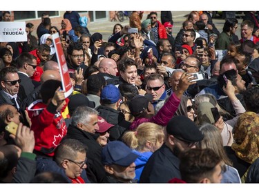 Liberal Party leader Justin Trudeau wades through a sea of supporters during a campaign stop at the campaign office of  London-Fashawe candidate Mohamed Hammoud in London, Ont. on Monday October 14, 2019. .Derek Ruttan/The London Free Press/Postmedia Network