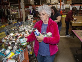 Volunteers Carolyn Best, left, Shelley Savage and  Dianne Weick sort donations at the London Food Bank on Monday Oct. 14, 2019. (Derek Ruttan/The London Free Press)